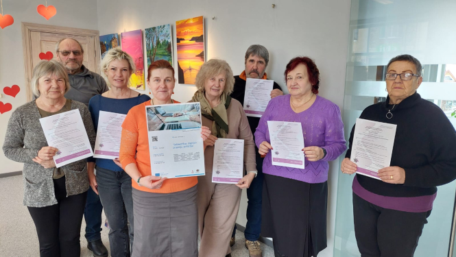 Foto ar mācību dalībniekiem, kas tur rokās savus sertifikātus