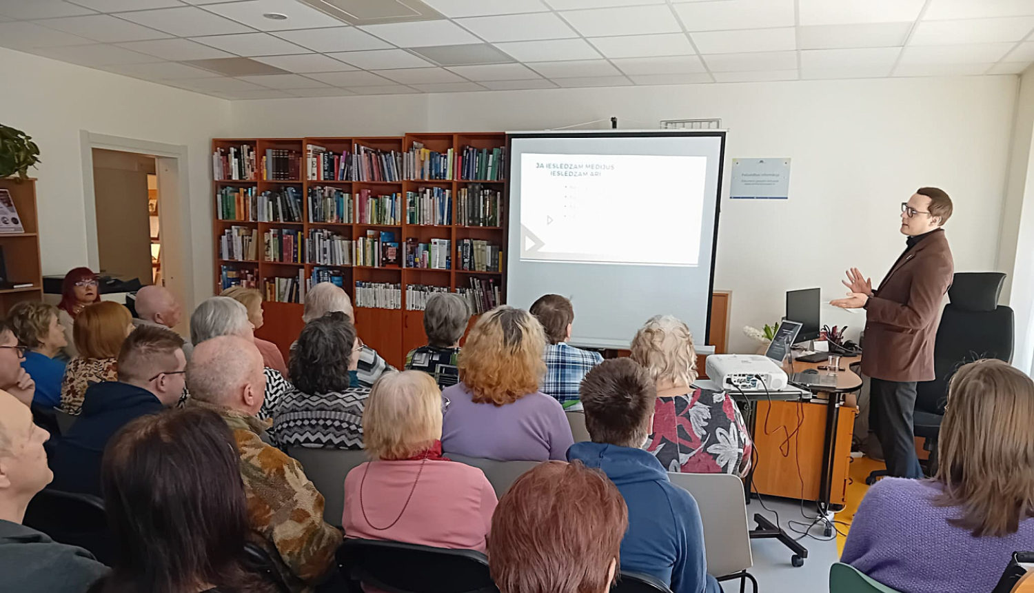 auditorija klausās lektoru